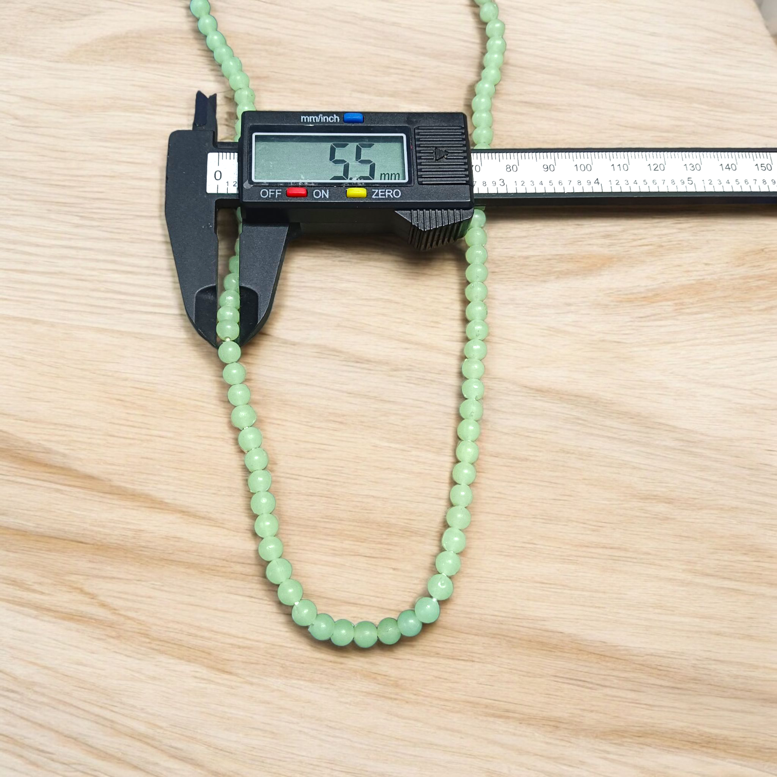 A Lab Certified Green Moti Mala made of 108+1 smooth, round green pearl beads, strung for japa, meditation, and spiritual healing