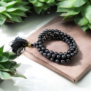 A Magnet Mala made with 108+1 smooth, round 8mm magnetic beads, neatly strung for healing, meditation, or spiritual wear
