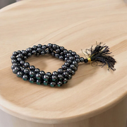 A Magnet Mala made with 108+1 smooth, round 8mm magnetic beads, neatly strung for healing, meditation, or spiritual wear