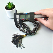 A Magnet Mala made with 108+1 smooth, round 8mm magnetic beads, neatly strung for healing, meditation, or spiritual wear