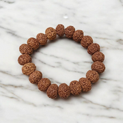 A Natural 8 Mukhi Rudraksha Bracelet made with 11mm round beads, hand-strung on elastic for comfort, symbolizing Lord Ganesha’s energy and protection