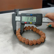 A Natural 8 Mukhi Rudraksha Bracelet made with 11mm round beads, hand-strung on elastic for comfort, symbolizing Lord Ganesha’s energy and protection