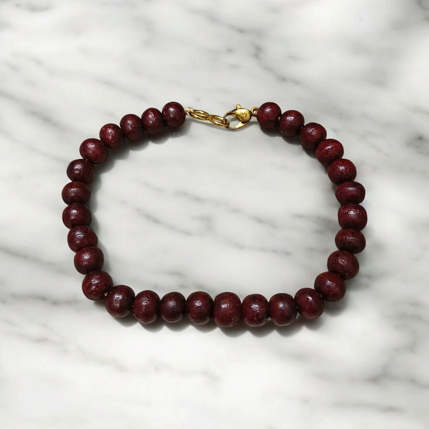 A Natural Red Sandalwood (Lal Chandan) Bracelet with 8mm polished beads, strung on stretchable thread, ideal for meditation and spiritual practice