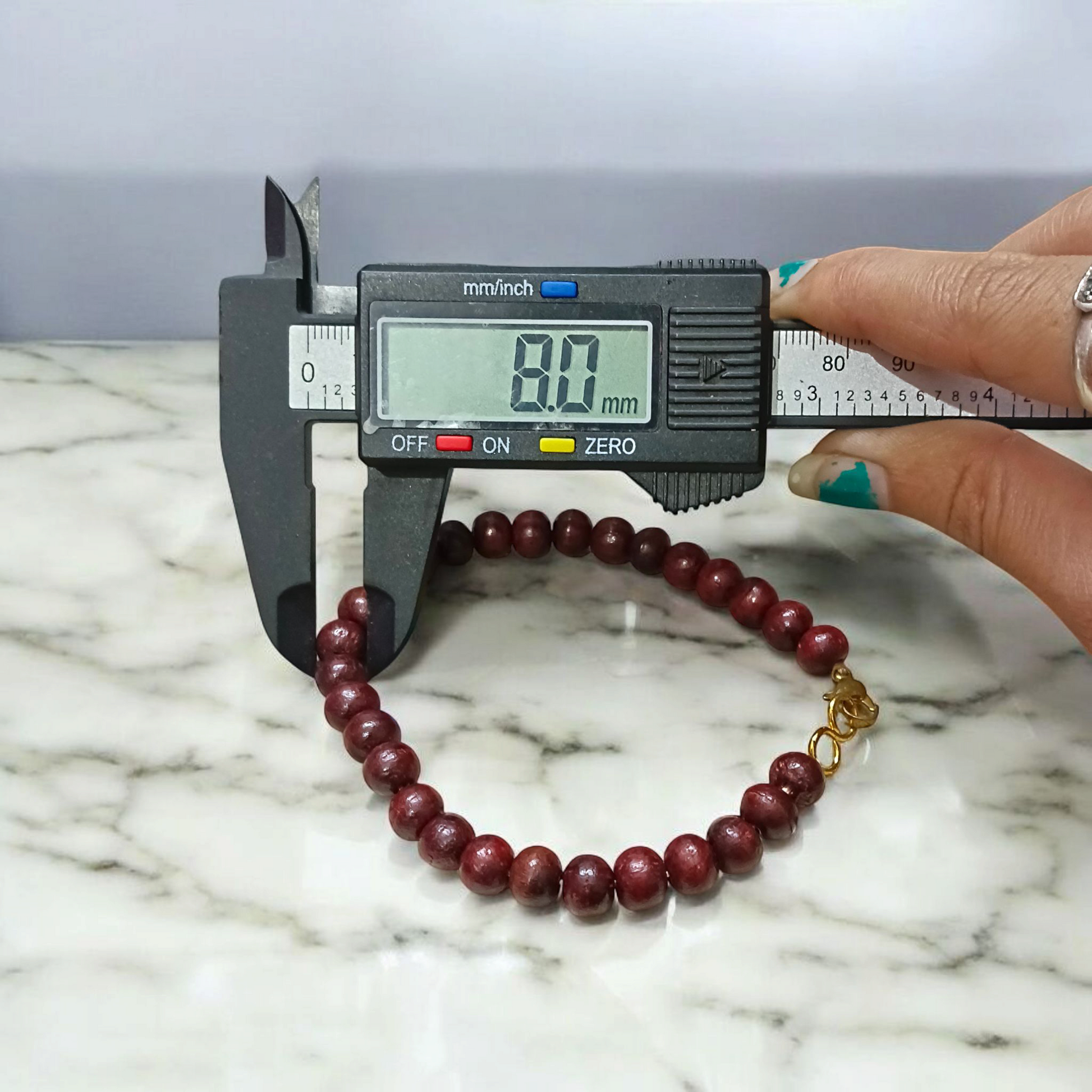 A Natural Red Sandalwood (Lal Chandan) Bracelet with 8mm polished beads, strung on stretchable thread, ideal for meditation and spiritual practice