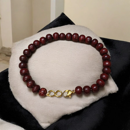 A Natural Red Sandalwood (Lal Chandan) Bracelet with 8mm polished beads, strung on stretchable thread, ideal for meditation and spiritual practice