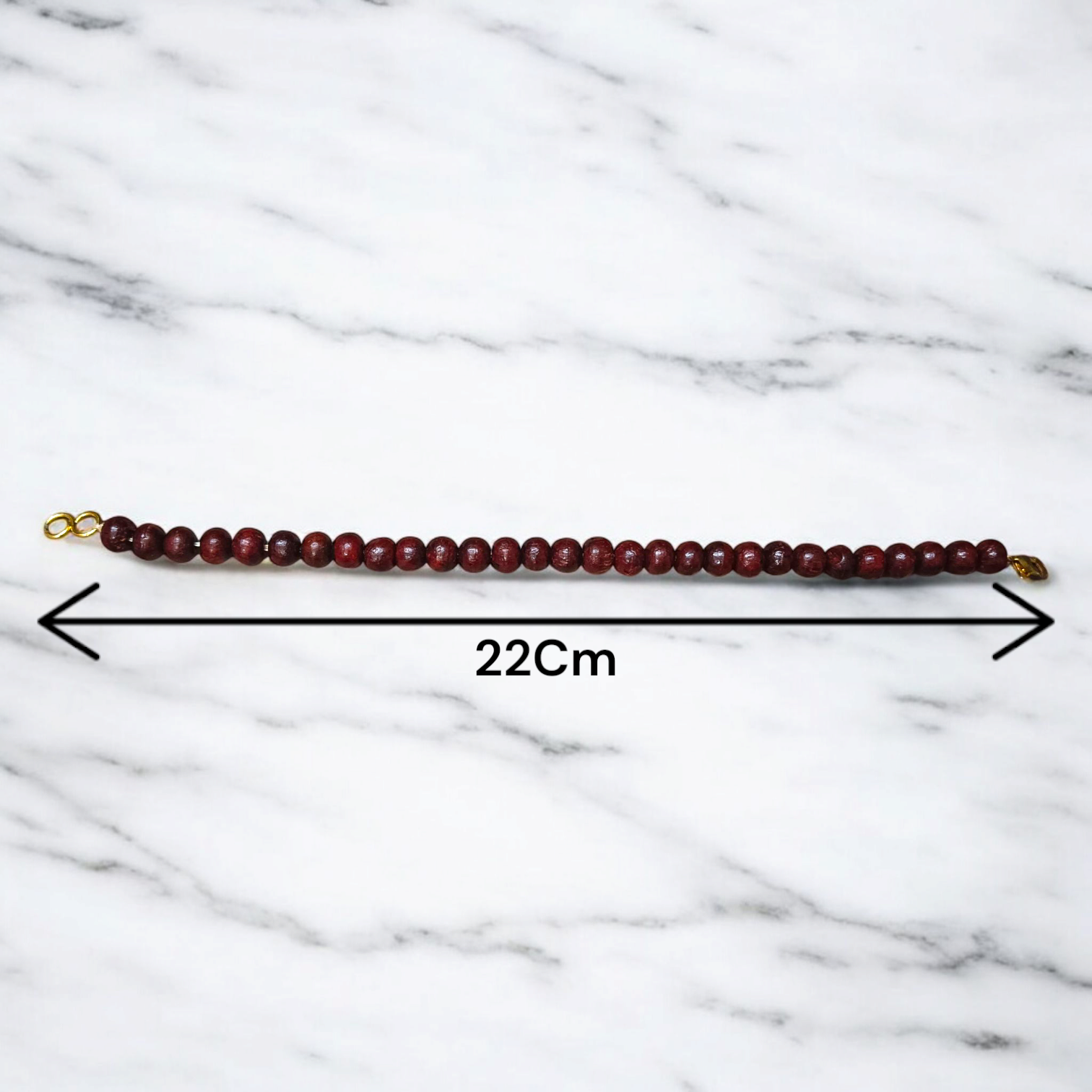 A Natural Red Sandalwood (Lal Chandan) Bracelet with 8mm polished beads, strung on stretchable thread, ideal for meditation and spiritual practice