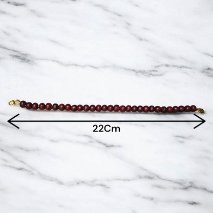 A Natural Red Sandalwood (Lal Chandan) Bracelet with 8mm polished beads, strung on stretchable thread, ideal for meditation and spiritual practice