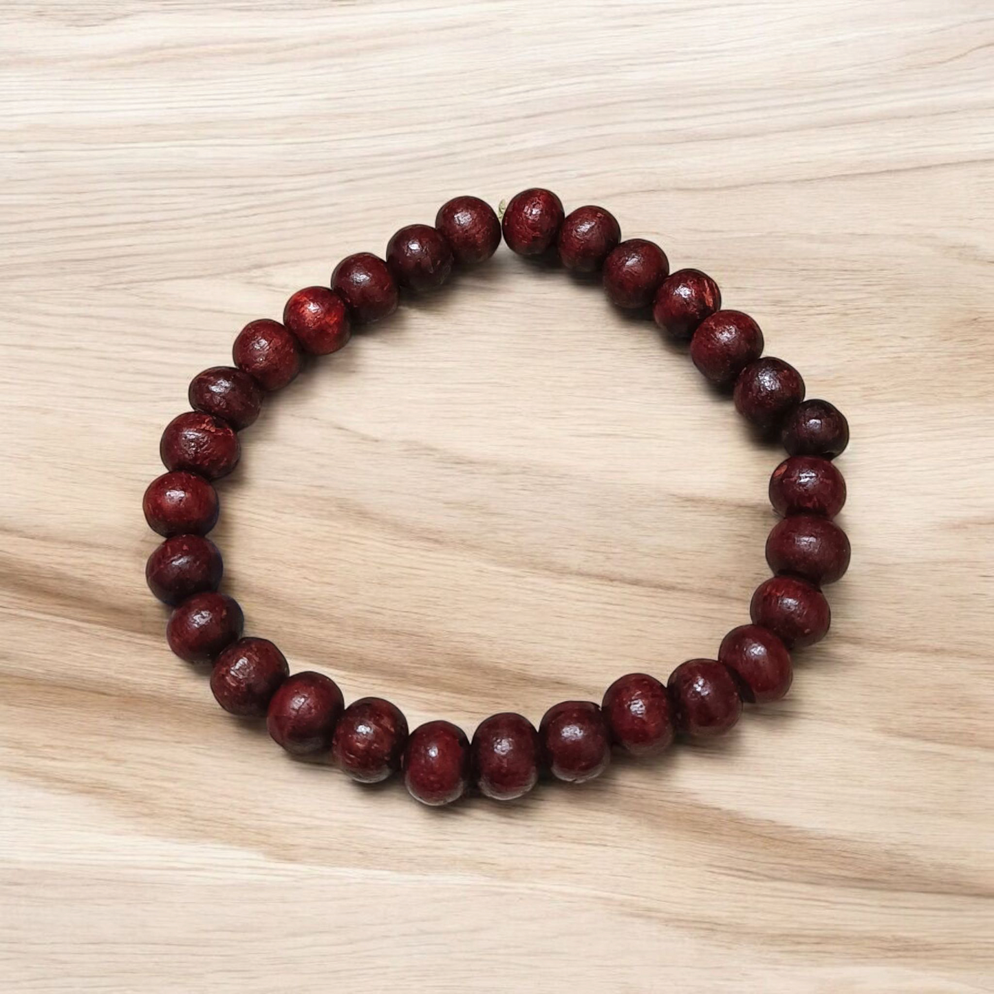 A Natural Red Sandalwood (Lal Chandan) Bracelet with 8mm polished beads, strung on stretchable thread, ideal for meditation and spiritual practice