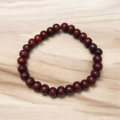A Natural Red Sandalwood (Lal Chandan) Bracelet with 8mm polished beads, strung on stretchable thread, ideal for meditation and spiritual practice