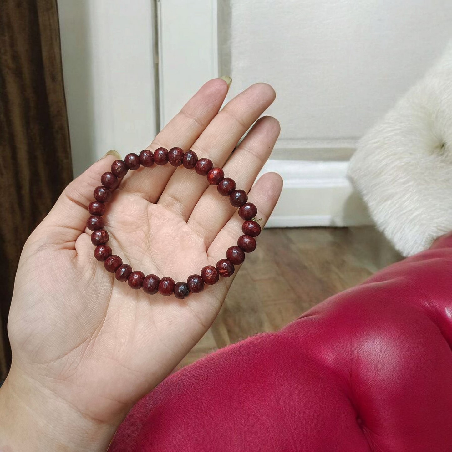 A Natural Red Sandalwood (Lal Chandan) Bracelet with 8mm polished beads, strung on stretchable thread, ideal for meditation and spiritual practice