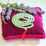 A beautiful 108+1 bead Green Moti Mala made of small, smooth pearl-like green beads strung for japa or spiritual wear