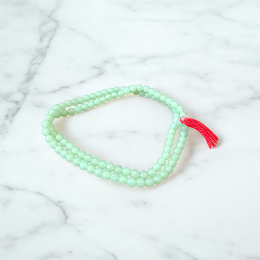 A beautiful 108+1 bead Green Moti Mala made of small, smooth pearl-like green beads strung for japa or spiritual wear