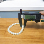 A beautiful 8mm stretchable natural pearl bracelet featuring round, white freshwater pearls on an elastic cord, ideal for healing and style