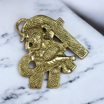 A beautifully crafted brass wall hanging of Lord Ganesha in 11×11 cm size, ideal for temple, home entrance, or office wall décor
