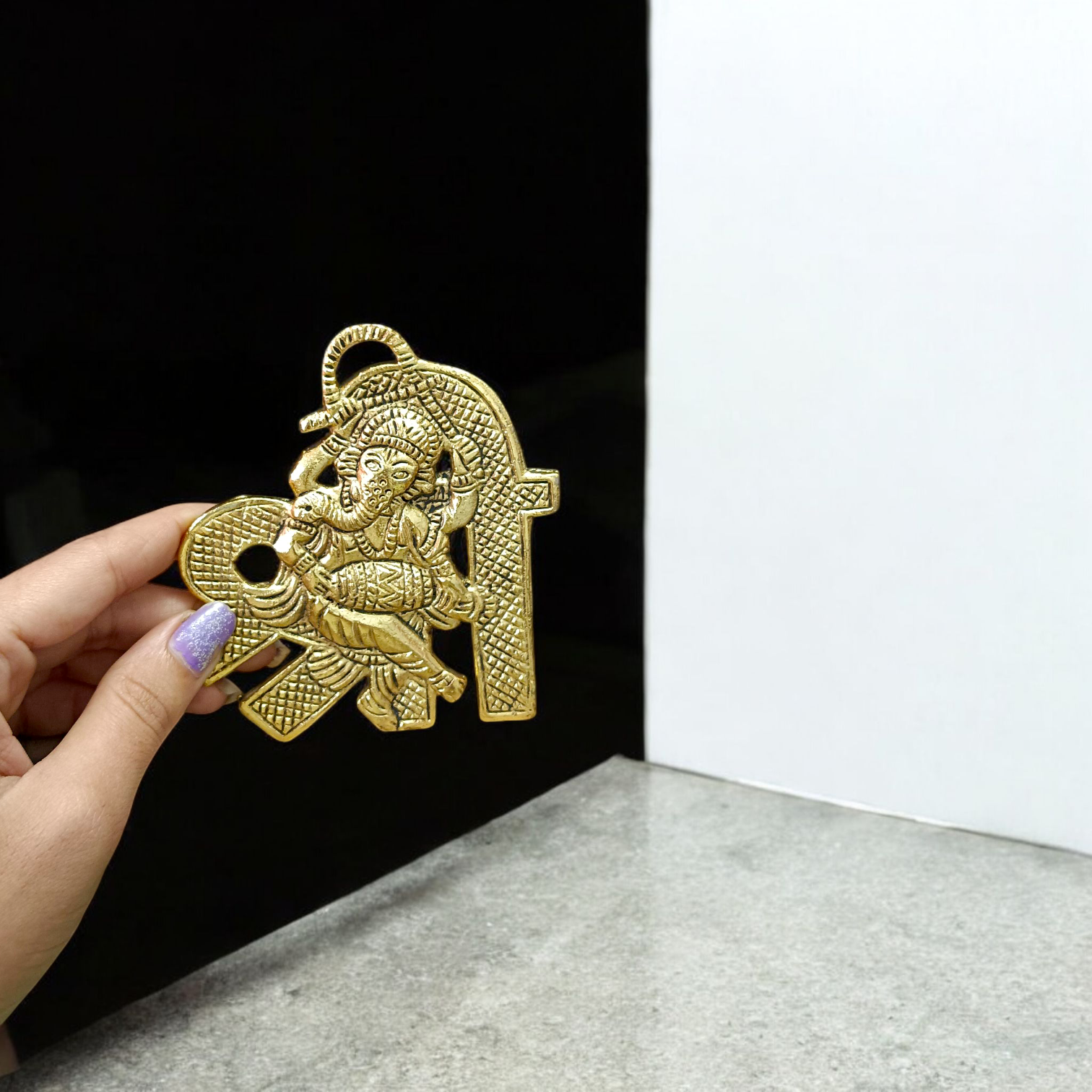 A beautifully crafted brass wall hanging of Lord Ganesha in 11×11 cm size, ideal for temple, home entrance, or office wall décor