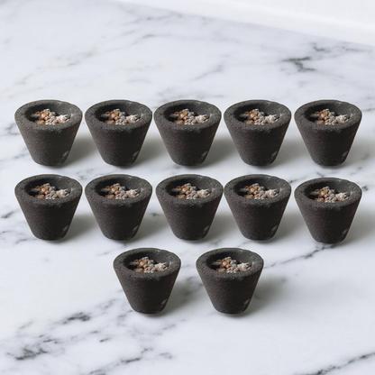 A box of MALAWALA Premium Cup Sambrani containing 12 natural dhoop cups arranged neatly, with one cup lit and emitting aromatic smoke