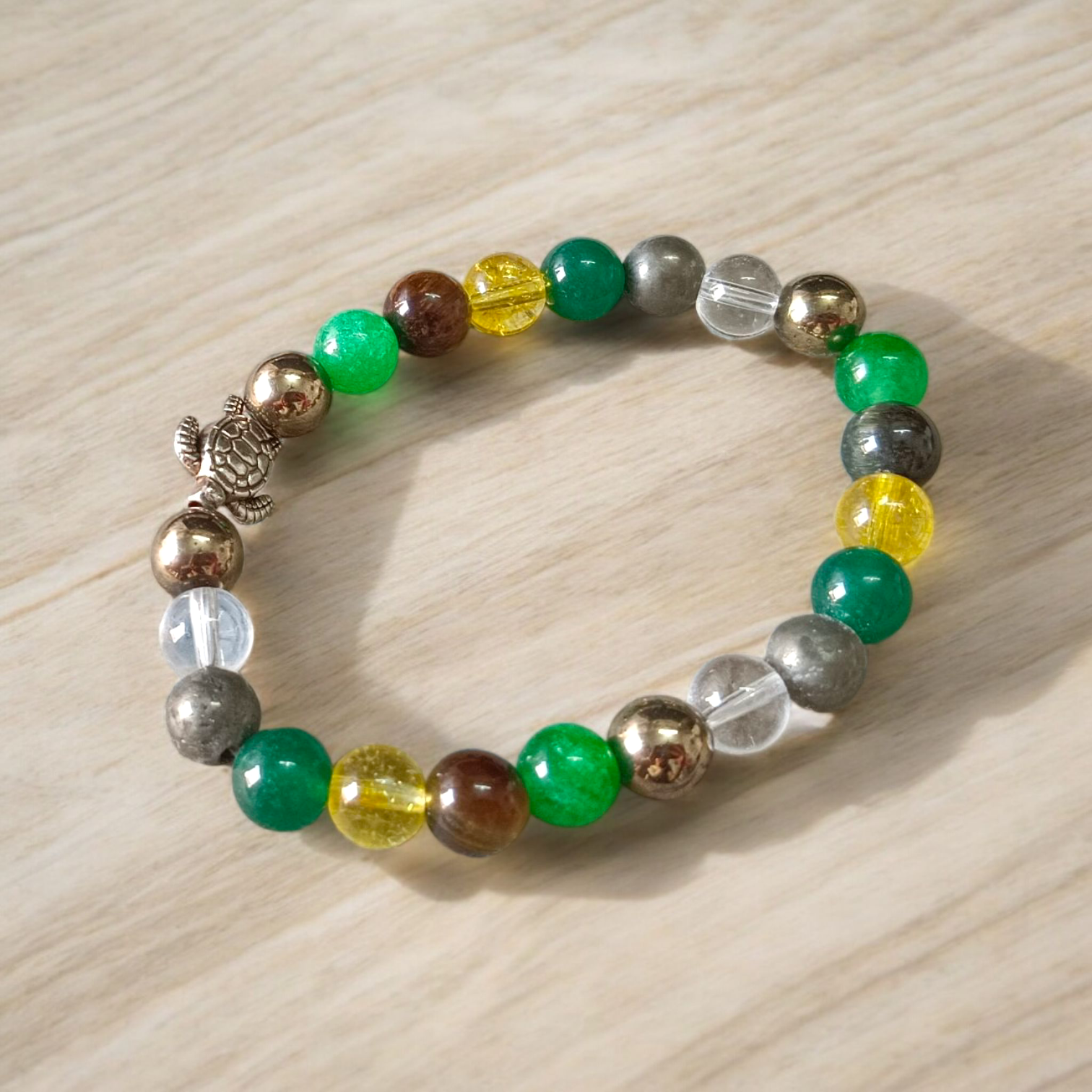 A handcrafted 8mm beaded Money Magnet Bracelet by MALAWALA featuring natural gemstone beads, designed to attract wealth and prosperity, displayed on a neutral background