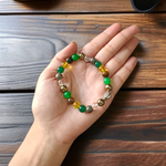 A handcrafted 8mm beaded Money Magnet Bracelet by MALAWALA featuring natural gemstone beads, designed to attract wealth and prosperity, displayed on a neutral background