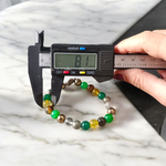 A handcrafted 8mm beaded Money Magnet Bracelet by MALAWALA featuring natural gemstone beads, designed to attract wealth and prosperity, displayed on a neutral background