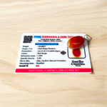 A handcrafted Natural Carnelian and Orange Aventurine pendant in sterling silver setting, displayed on a wooden background