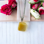 A handcrafted Yellow Aventurine stone pendant with a polished oval gemstone set in a sleek metal frame, suitable for men and women