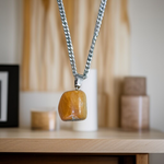 A handcrafted Yellow Aventurine stone pendant with a polished oval gemstone set in a sleek metal frame, suitable for men and women