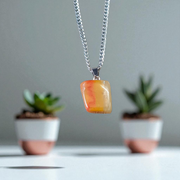 A handcrafted Yellow Aventurine stone pendant with a polished oval gemstone set in a sleek metal frame, suitable for men and women