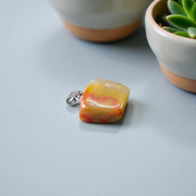 A handcrafted Yellow Aventurine stone pendant with a polished oval gemstone set in a sleek metal frame, suitable for men and women