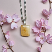 A handcrafted Yellow Aventurine stone pendant with a polished oval gemstone set in a sleek metal frame, suitable for men and women