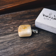 A handcrafted Yellow Aventurine stone pendant with a polished oval gemstone set in a sleek metal frame, suitable for men and women