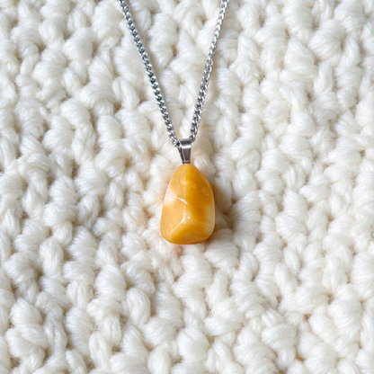 A handcrafted Yellow Aventurine stone pendant with a polished oval gemstone set in a sleek metal frame, suitable for men and women