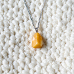 A handcrafted Yellow Aventurine stone pendant with a polished oval gemstone set in a sleek metal frame, suitable for men and women