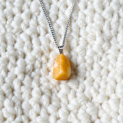 A handcrafted Yellow Aventurine stone pendant with a polished oval gemstone set in a sleek metal frame, suitable for men and women
