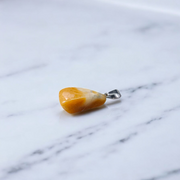 A handcrafted Yellow Aventurine stone pendant with a polished oval gemstone set in a sleek metal frame, suitable for men and women