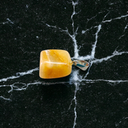 A handcrafted Yellow Aventurine stone pendant with a polished oval gemstone set in a sleek metal frame, suitable for men and women
