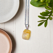 A handcrafted Yellow Aventurine stone pendant with a polished oval gemstone set in a sleek metal frame, suitable for men and women
