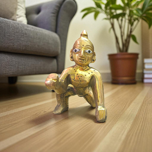 A handcrafted brass Laddu Gopal statue in crawling pose, available in sizes 0 to 6, ideal for temple and home worship