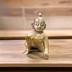 A handcrafted brass Laddu Gopal statue in crawling pose, available in sizes 0 to 6, ideal for temple and home worship