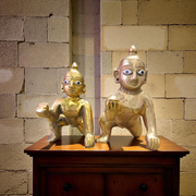 A handcrafted brass Laddu Gopal statue in crawling pose, available in sizes 0 to 6, ideal for temple and home worship