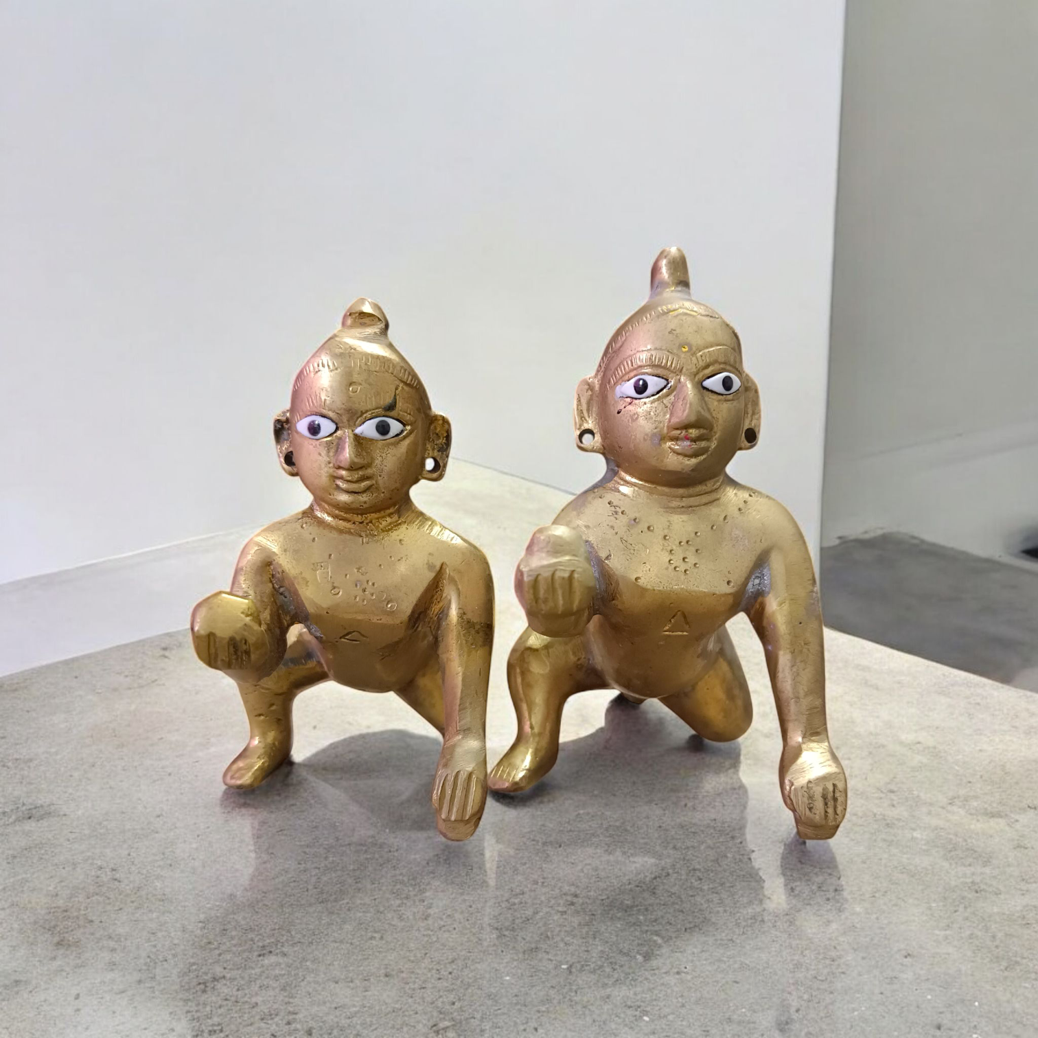 A handcrafted brass Laddu Gopal statue in crawling pose, available in sizes 0 to 6, ideal for temple and home worship