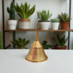 A handcrafted brass pooja bell with Garuda engravings, ideal for temple and home rituals