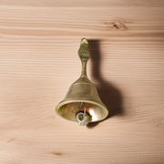 A handcrafted brass pooja bell with Garuda engravings, ideal for temple and home rituals