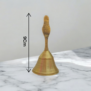 A handcrafted brass pooja bell with Garuda engravings, ideal for temple and home rituals