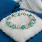A handcrafted gemstone bracelet made with white agate and coconut blue chalcedony beads, elegantly strung on an adjustable elastic band