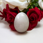 A handcrafted white and black marble Shivling placed on a clean surface, ideal for Tulsi or temple worship