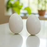 A handcrafted white marble Shivling stone, smooth and polished, ideal for placing under Tulsi plant, home temple, or personal worship altar