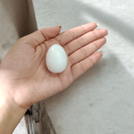 A handcrafted white marble Shivling stone, smooth and polished, ideal for placing under Tulsi plant, home temple, or personal worship altar