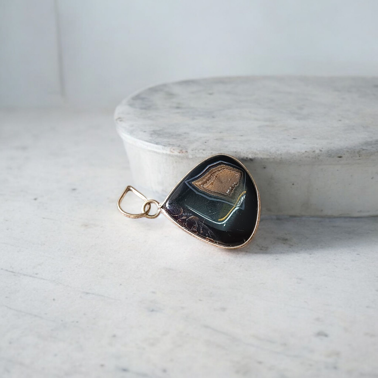 A lab-certified Natural Sulemani Pendant with a polished black agate stone set in sterling silver, displayed on a clean white background