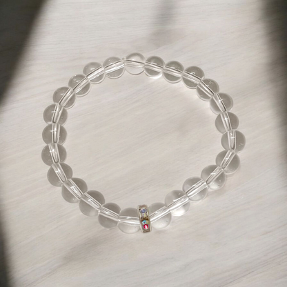 A lab-certified natural Sphatik crystal bracelet with polished 7mm beads, handcrafted and stretchable, resting on a soft white background