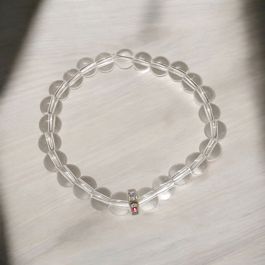A lab-certified natural Sphatik crystal bracelet with polished 7mm beads, handcrafted and stretchable, resting on a soft white background
